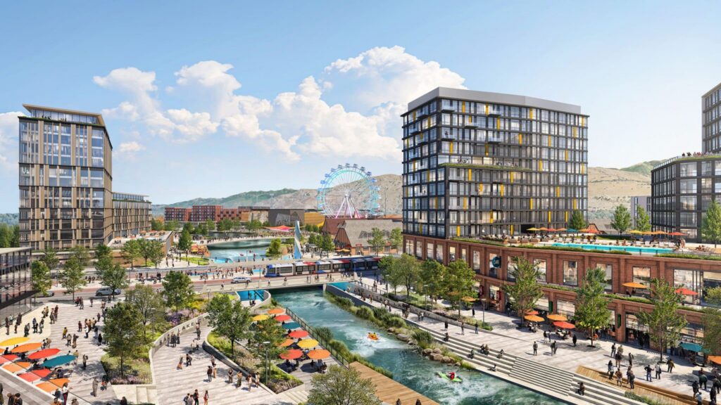 A modern urban development in the Salt Lake westside business district with tall buildings, a canal, pedestrian walkways, outdoor seating, trees, and a Ferris wheel in the background under a blue sky.