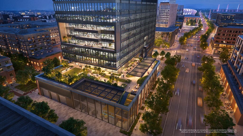 A modern office building with rooftop terraces and outdoor seating is illuminated at dusk in the heart of North Temple Jordan River, surrounded by city streets and nearby buildings.