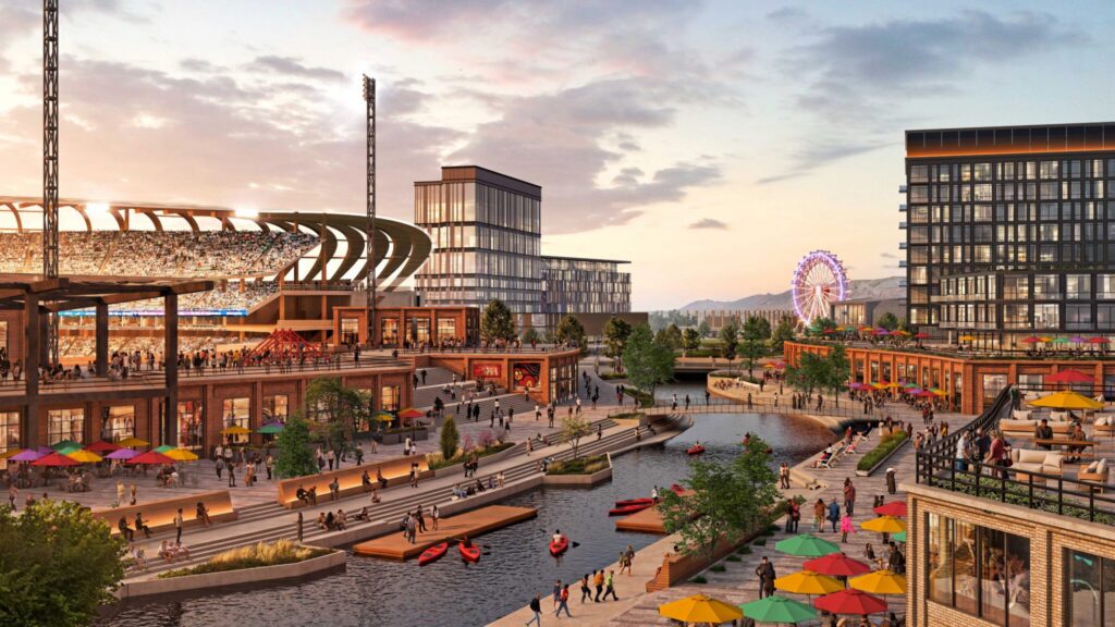 A lively Salt Lake westside business district with a stadium, modern buildings, outdoor seating, people walking along a canal, kayakers on the water, and a Ferris wheel in the background at sunset.