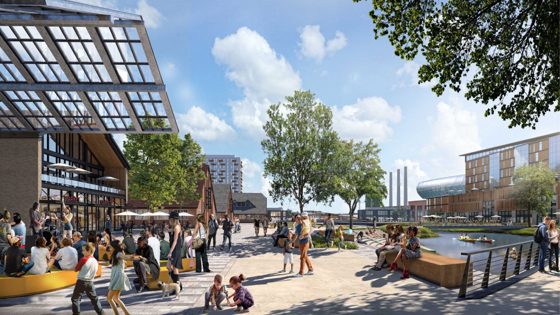 Personas se reúnen en una plaza urbana al aire libre cerca del agua, rodeada de árboles, edificios modernos y asientos al aire libre en el corazón del desarrollo de uso mixto totalmente eléctrico del distrito de negocios del oeste de Salt Lake en un día soleado.
